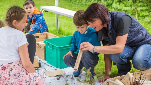 Children making bug hotels